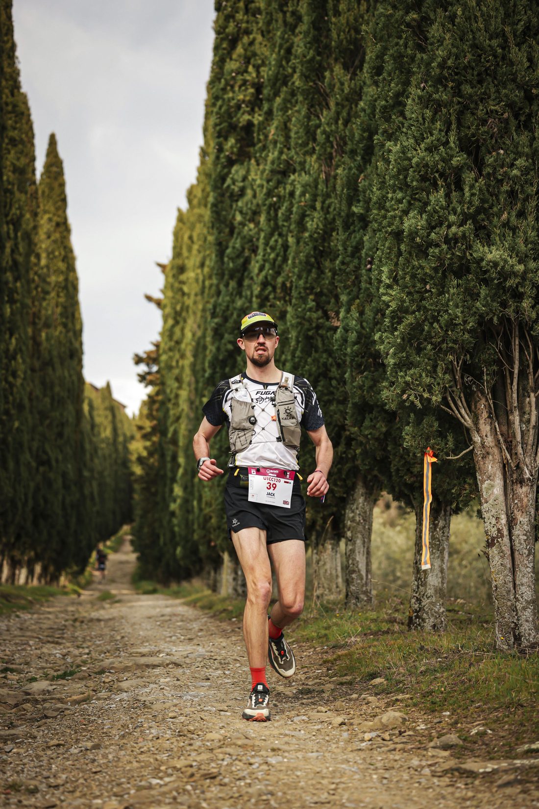 Jack Chamberlain running an avenue of cypress trees at the Chianti Ultra Trail.