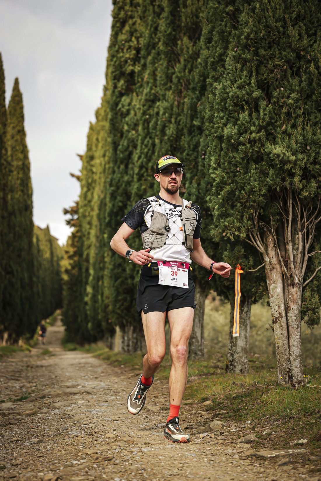 Jack Chamberlain running up a cypress-lined track at the Chianti Ultra Trail.