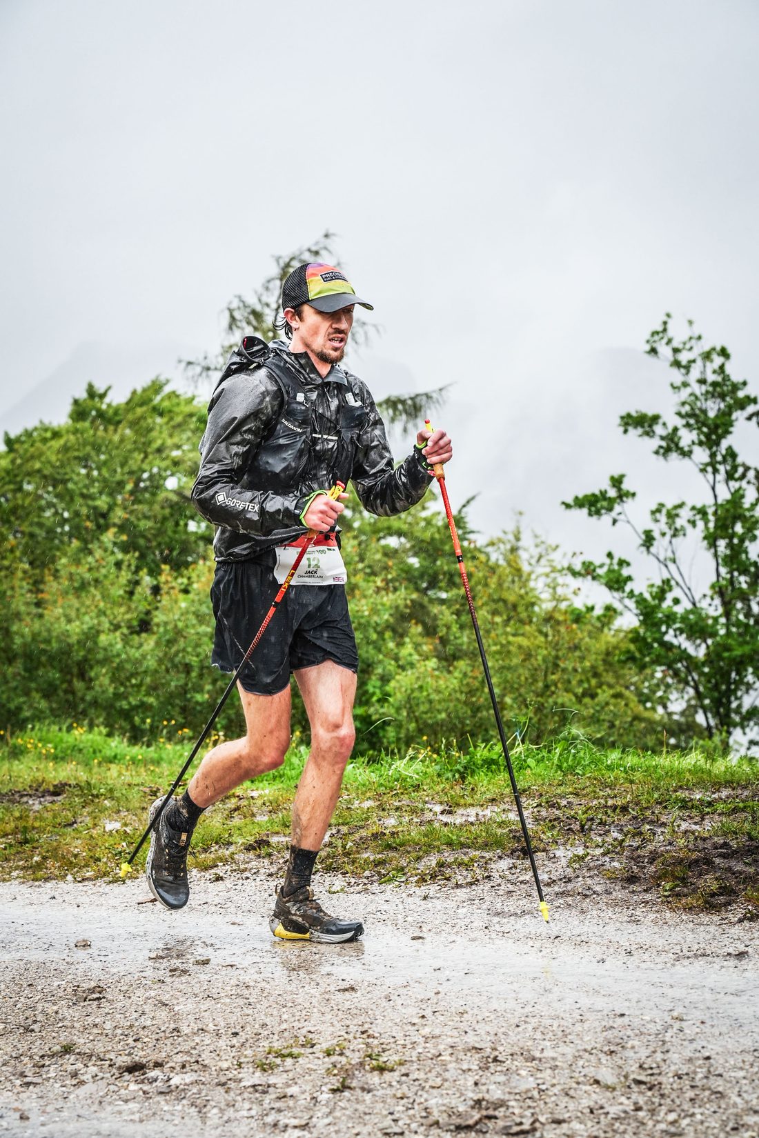 Jack Chamberlain running a wet trail in the rain at the Mozart 100 by UTMB.