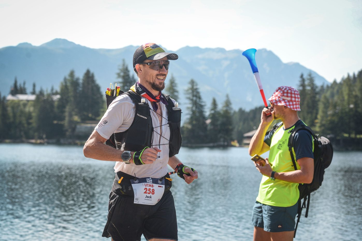Jack Chamberlain beside an alpine lake with his daughter during UTMB Mont-Blanc.