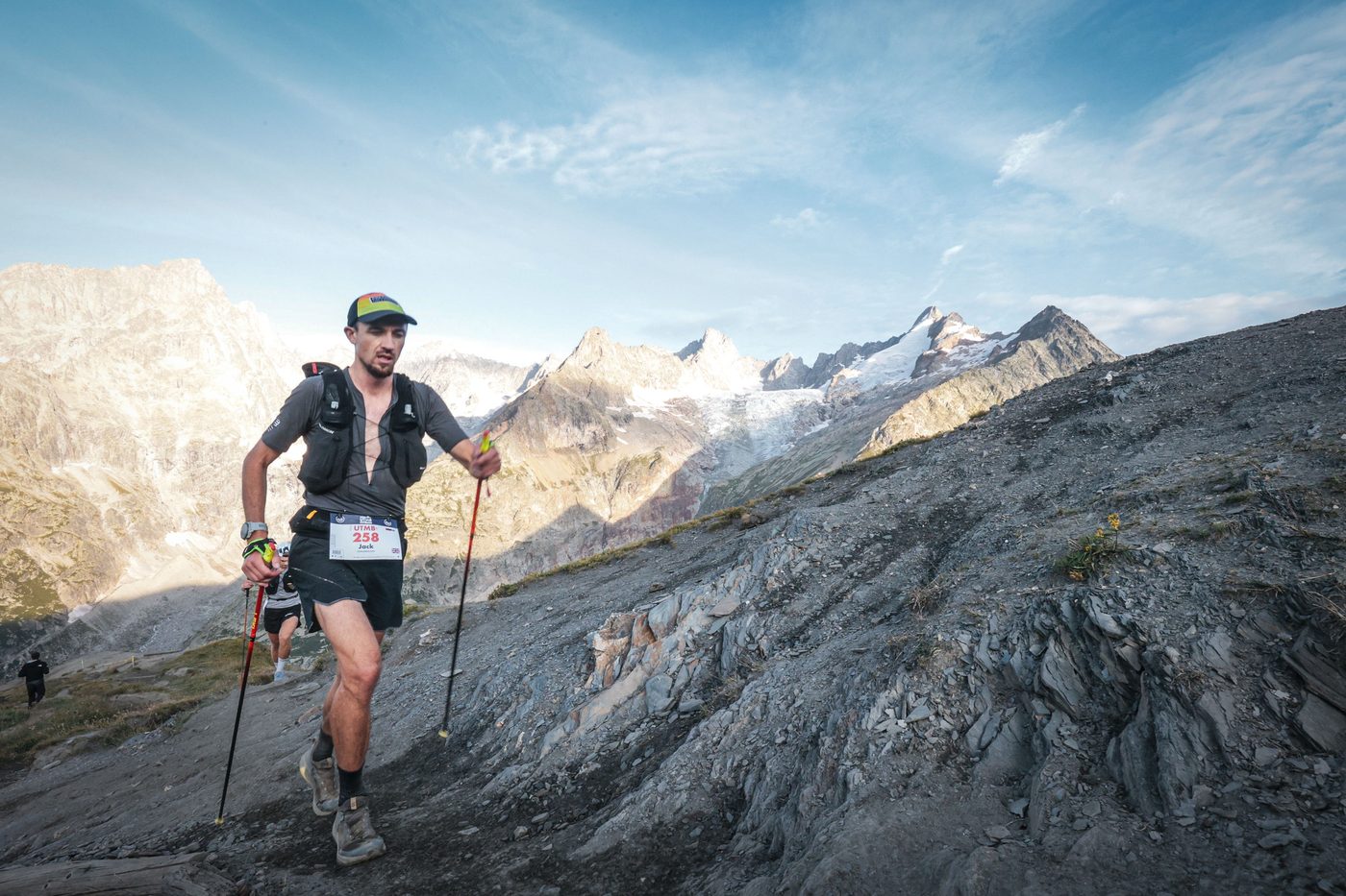 Jack Chamberlain climbing a glacial moraine with poles during UTMB Mont-Blanc.