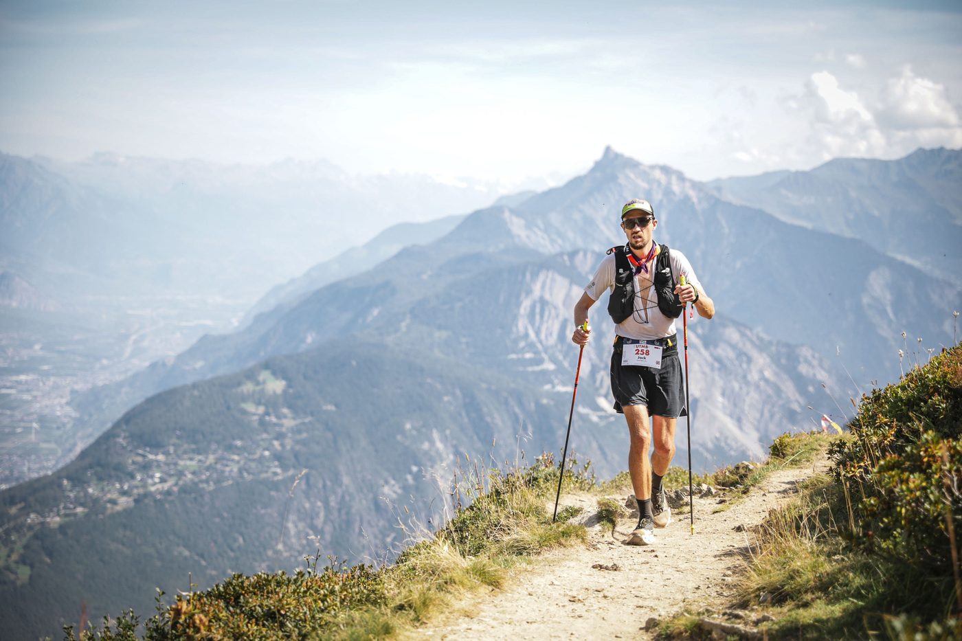 Jack Chamberlain hiking with poles high above the Chamonix valley at UTMB Mont-Blanc.